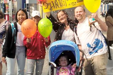 Gastfamilie und Austauschschüler stehen zusammen am Bahnhof. 