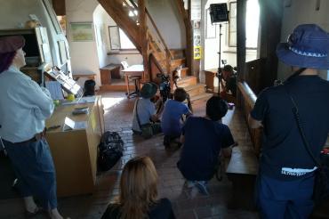 Auf dem Bild: Turmkatze „Wendelstein“ mit Mitsuaki Iwago (grüne Schildmütze) bei den Dreharbeiten