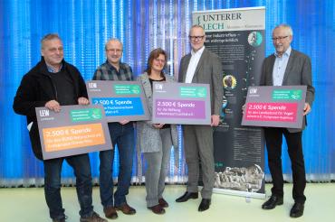 10.000 Euro für Naturschutz und Umweltbildung am unteren Lech: LEW-Vorstandsmitglied Dr. Markus Litpher (2.v.r.) übergibt in der LEW Energiewelt in Augsburg die symbolischen Spendenschecks an Rudolf Schubert, 2. Vorsitzender der Kreisgruppe Donau-Ries des Bund Naturschutz (links), Ulrich Krafczyk, Geschäftsführer des Fischereiverbands Schwaben (2.v.l.), Birgitt Kopp, Geschäftsführerin Lebensraum Lechtal, und Dietrich Peter, stellvertretender Vorsitzender der Kreisgruppe Augsburg des Landesbunds für Vogelsch