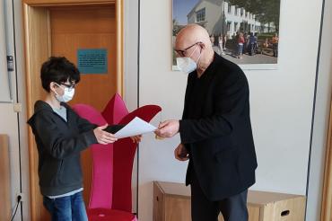 Das Bild zeigt Johann Enderle vom Autorenclub, der Robert Mährle, dem Sieger des Schreibwettbewerbs, seinen Preis überreicht.