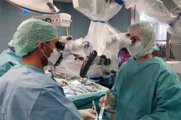 Das Bild zeigt die Ärzte beim Arbeiten mit dem neuen Mikroskop.