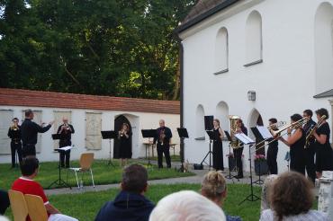 Das Ensemble von Gloria Brass unter der Leitung von Kirchenmusikdirektor Dieter Wendel vor der Löpsinger St. Michaelskirche