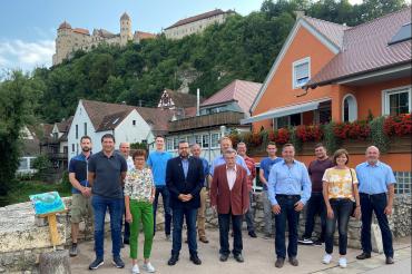 Vorstandschaft CSU Harburg steht am Wörnitzufer, im Hintergrund die Harburg