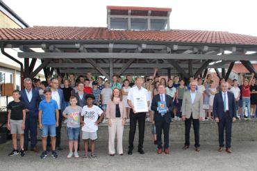 Mehrere Personen, darunter viele Kinder, vor einer Überdachung