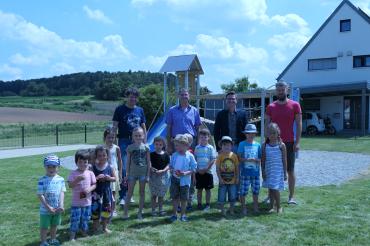 Von links hintere Mitte: Michael Stiller (Ortssprecher Herkheim) und Oberbürgermeister David Wittner, umgeben von Kindern und Eltern aus Herkheim