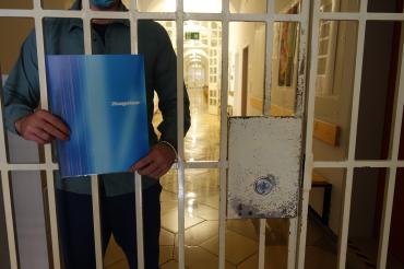 Das Bild zeigt einen Inhaftierten mit Zeugnis.