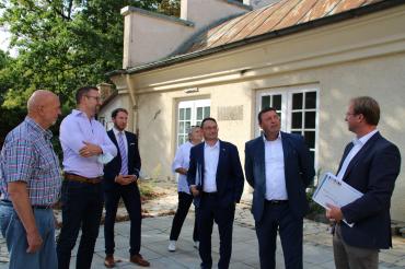 Sieben Personen stehen auf Terrasse vor Kronensaal Oettingen