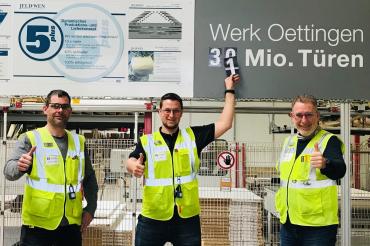 Zu sehen sind Christoph Mayer, Sven Weigl und Wolfgang Oswald beim Überkleben der Zähltafel.