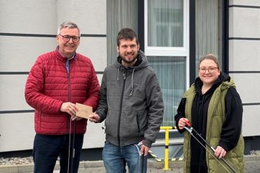 Zu sehen sind Gerhard Wiedemann, Florian Gröger und Victoria Bauer bei der Übergabe des Gutscheines. 