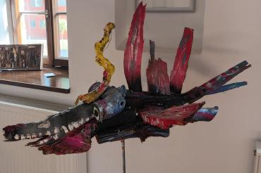 Zu sehen ist eine bemalte Holzskulptur.