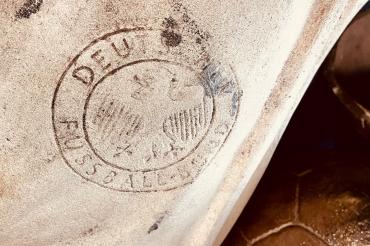 Das Bild zeigt das Logo vom Deutschen Fußballbund auf einer Statue.