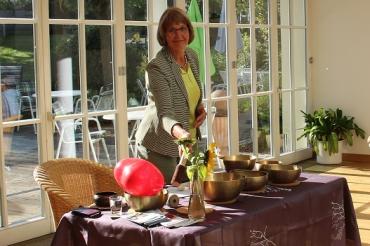 Das Bild zeigt Mechtihild Laforet mit Klangschalen beim Wohlfühlfrühstück.