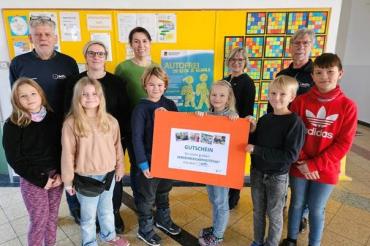 Das Bild zeigt Schülerinnen und Schüler der Grundschule Hainsfarth sowie von links nach rechts Herrn Johannes Thum (ADFC Donau-Ries), Frau Ursula Leinfelder (Familienbeauftragte des Landkreises Donau-Ries), Frau Birgit Ammesdörfer und Frau Marlene Sporer (beide Grundschule Hainsfarth) und Herrn Hans-Peter Hanisch (ADFC Donau-Ries) bei der Übergabe des Hauptpreis-Gutscheins in der Grundschule Hainsfarth.