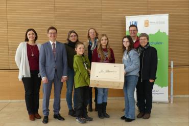 Auf dem Foto von links nach rechts: Lena Pollak (Leiterin der Klimaschutz-AG), Oberbürgermeister David Wittner, Simone Meißler (Zweite Vorsitzende des Elternbeirats), Jonathan Bube (Schüler der AG Klimaschutz), Karin Frank (Kommunalbetreuerin der LEW-Bildungsinitiative), Johanna Bruglachner (AG Klimaschutz), Andrea Kauder (AG Klimschutz), Jochen Seefried (Fachbetreuer Physik), Dr. Renate Rachidi (Schulleiterin).