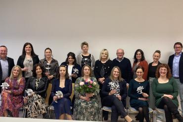Bürokauffrauen mit Blumen in der Hand.