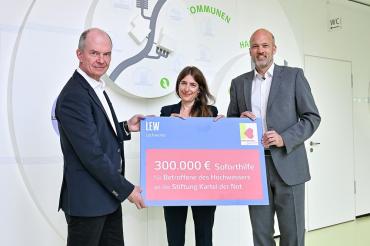 Die LEW-Vorstände Dietrich Gemmel und Christian Barr bei der Spendenübergabe mit Olivia Uhl-Baumm von der Kartei der Not