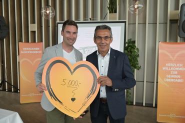 Bei der symbolischen Übergabe des Spendenbetrags in München: Markus Eichenseer, Geschäftsführender Vorstand des Gewinnsparvereins (links) und Erwin Taglieber, zweiter Vorsitzender des Vereins „1.000 Schulen für die Welt.“