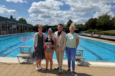 Oberbürgermeister David Wittner (2. v. r.), Simone Leidel (links, stellvertretende Leitung des Sachgebiets Liegenschaften, Schulen, Sport) und Nicole Hofmann (rechts, stellvertretende Betriebsleiterin der Bäder) gratulieren der 50.000. Besucherin Lena Steinle (2. v. l.).