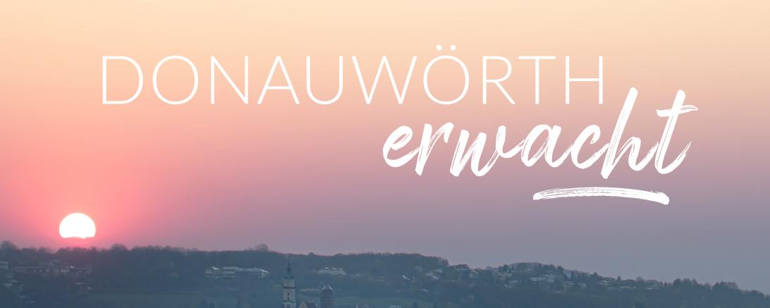 Sonnenaufgang über Donauwörth mit Schriftzug "Donauwörth erwacht"