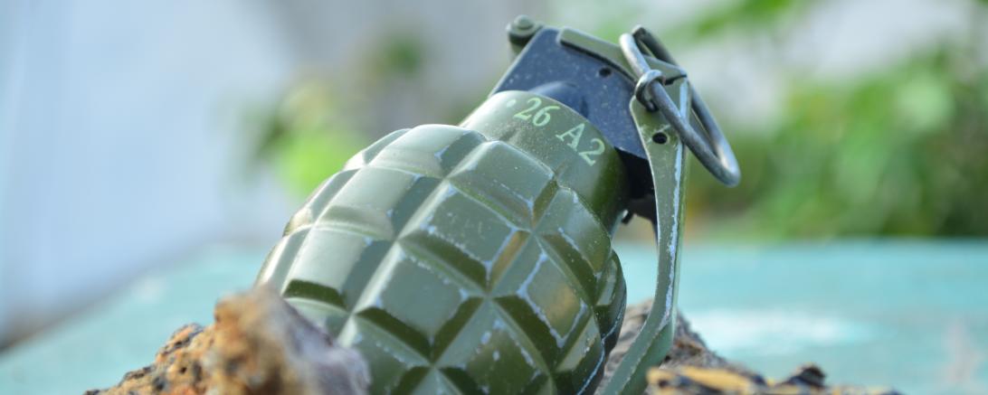 Handgranate auf dem Boden zwischen Steinen