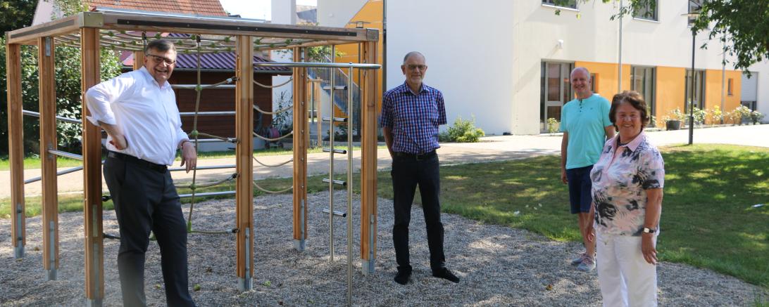 Das Bild zeigt (von links) Paul W. Ritter (Vorsitzender des Stiftungsbeirat Margarete-Jaumann-Stiftung), Christian Zuber (1. Vorsitzender des Fördervereins Katholisches Kinderheim Oettingen) und German Fall (2. Vorsitzender) und Mina Götz (stellvertretende Vorsitzende Stiftungsbeirat Margarete-Jaumann-Stiftung) am Klettergerüst vor dem neuen Anbau des Oettinger Kinderheims. 