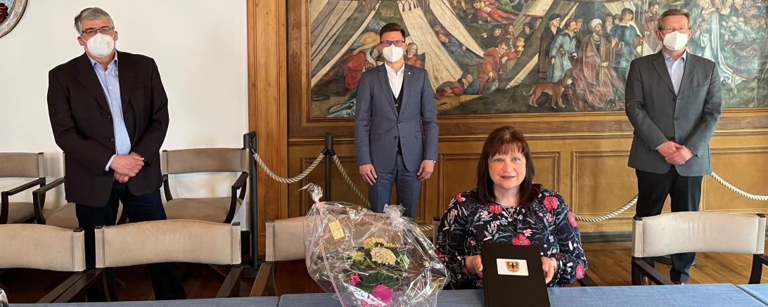 Das Bild zeigt Frau Anita Stoller bei ihrer Verabschiedung. Hinten von Links: Stadtarchivar Dr. Wilfried Sponsel, Oberbürgermeister David Wittner, Hauptamtsleiter Peter Schiele. 