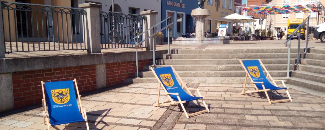 Blaue Liegestühle mit dem Stadtwappen versehen