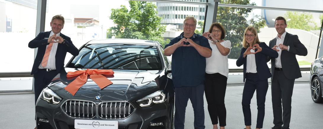 Auf dem Bild zu sehen Familie Volt beim Abholen des Autos.