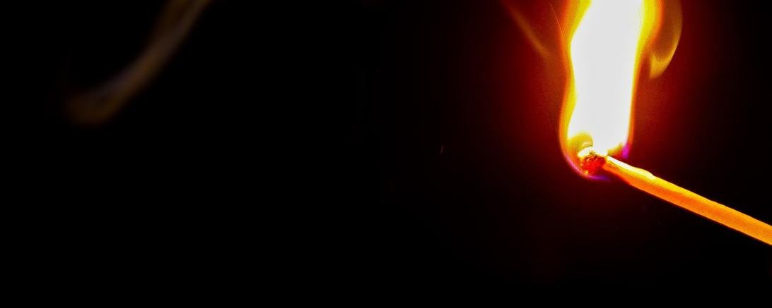 Das Bild zeigt ein entzundenes Streichholz