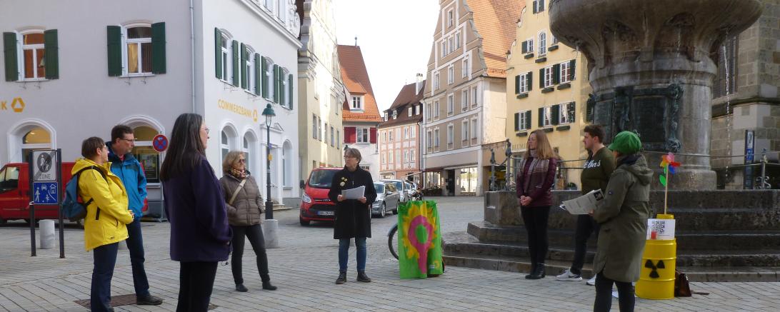 Das Bild zeigt Personen bei der Mahnwache am Kriegerbrunnen.
