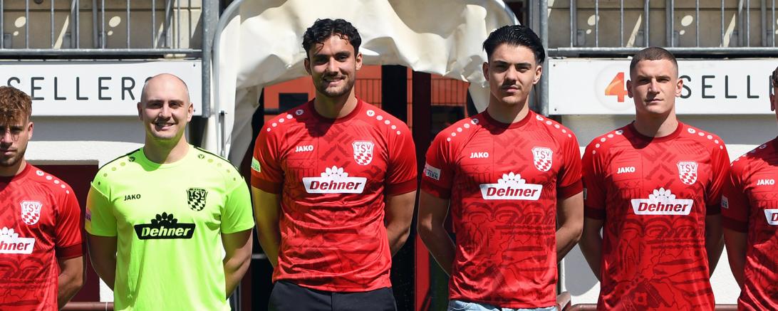 acht Männer in Fußballtrikos