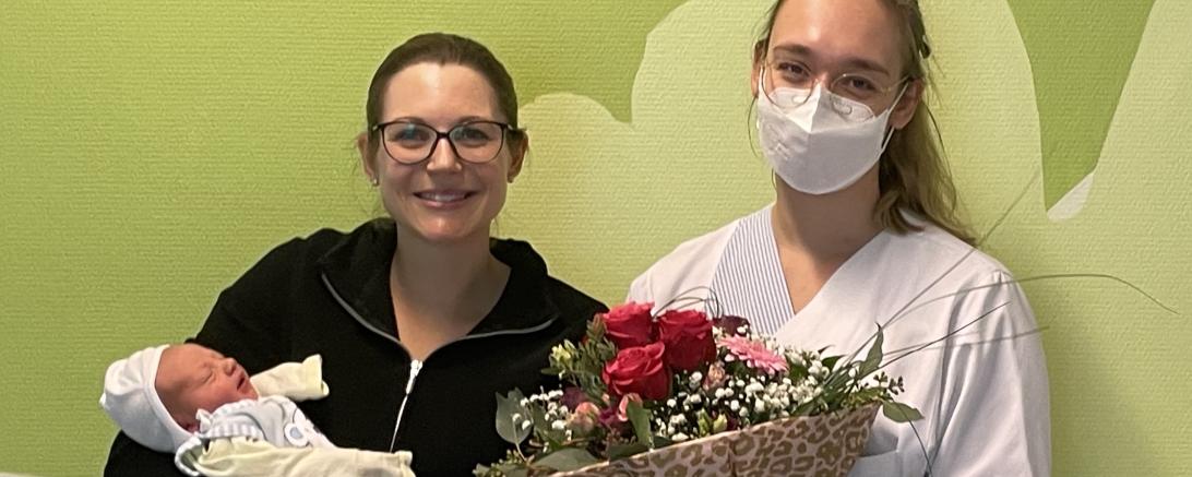 Mutter Julia Scherer trägt ihr Jubiläums-Baby Lorenz voller Stolz. Krankenschwester Katharina Hötzl gratulierte mit Blumen.