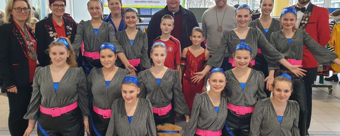 Der Marktorganisator Simon Briglmeier (hintere Reihe 3. von rechts) freute sich, dass neben vielen Kundinnen und Kunden auch Pfarrer Jörg Biercher (hintere Reihe4. von rechts) und die Kindergarde mit ihren Verantwortlichen beim Faschingsmarkt zu Gast waren. 