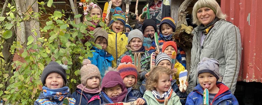 Die Kinder und Erzieherin Christiane Koffler (Mitte rechts) freuten sich über die Spende, die Marietta Schmidt (oben rechts), Organisatorin des Bürstenflohmarkts, vor Ort im Waldkindergarten übergab.
