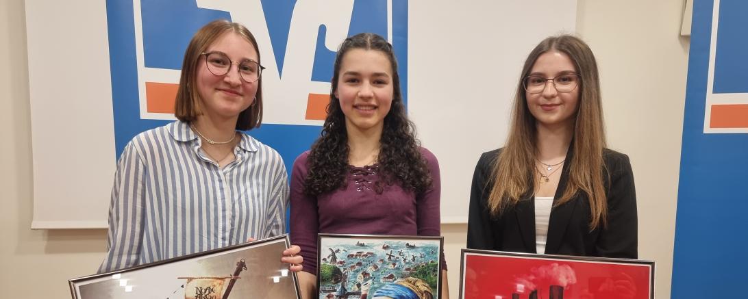 Drei Personen die Jeweils ein Bild in der Hand halten