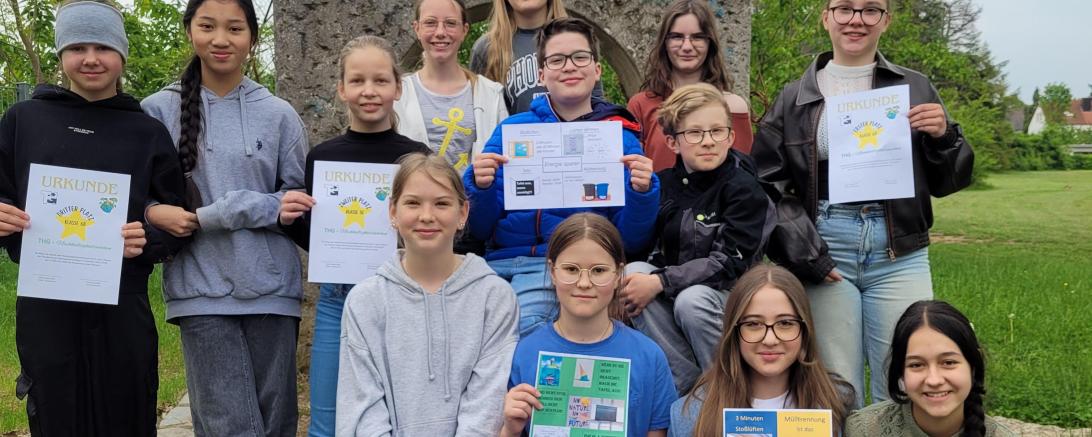 Die Mitglieder der AG Klimaschule mit den selbst gestalteten Energiespar-Plakaten sowie den Urkunden für die Gewinnerklassen.