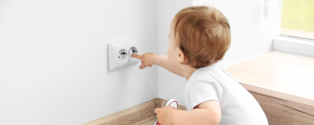 Kind fasst in Steckdose